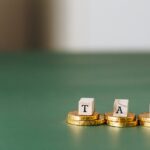 tax word on top of gold coins