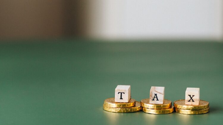 tax word on top of gold coins