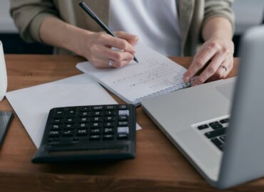 person calculating on a notebook