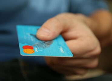 person holding debit card