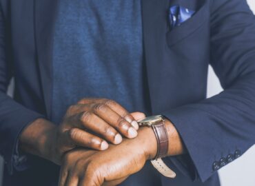 standing man looking his watch