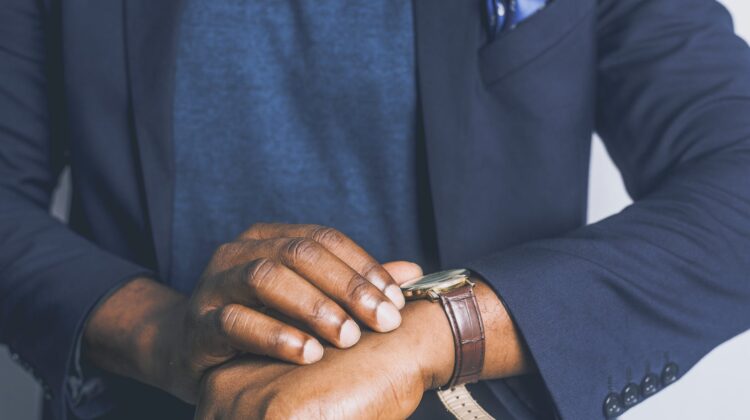 standing man looking his watch